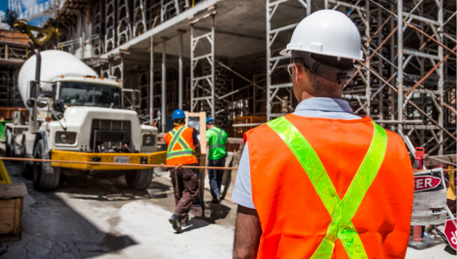 Construction Services: Who We Serve | Blue & Co., LLC | Man in safety vest on construction site