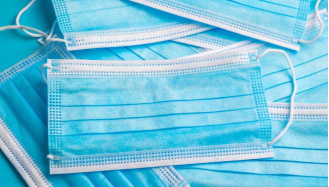 Pile of blue masks | Vaccine Mandates in the Workplace | COVID-19 Vaccine Mandates in the Workplace | COVID-19 Vaccine Mandate
